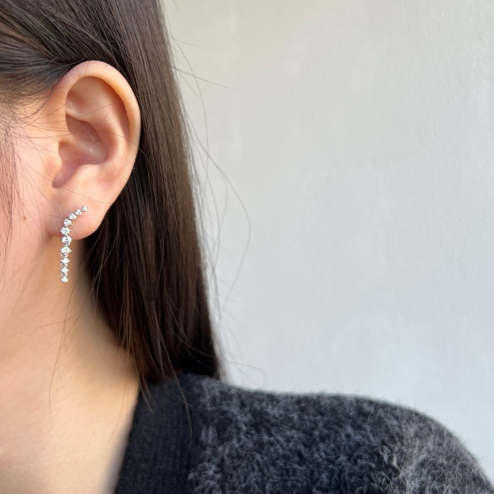 A sophisticated drop earring featuring a series of cubic zirconia stones set in a hoop design, crafted from 925 Sterling Silver.