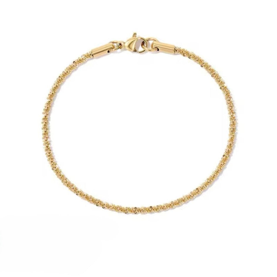 Spiral Gold bracelet on a white background