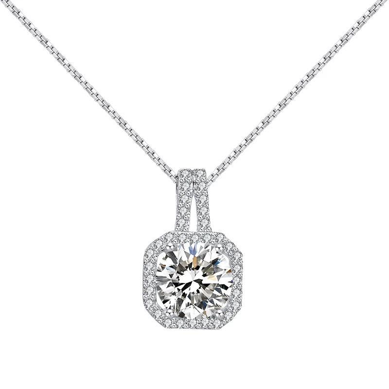 A sterling silver pendant necklace with a clear central gemstone surrounded by smaller stones in a square setting.