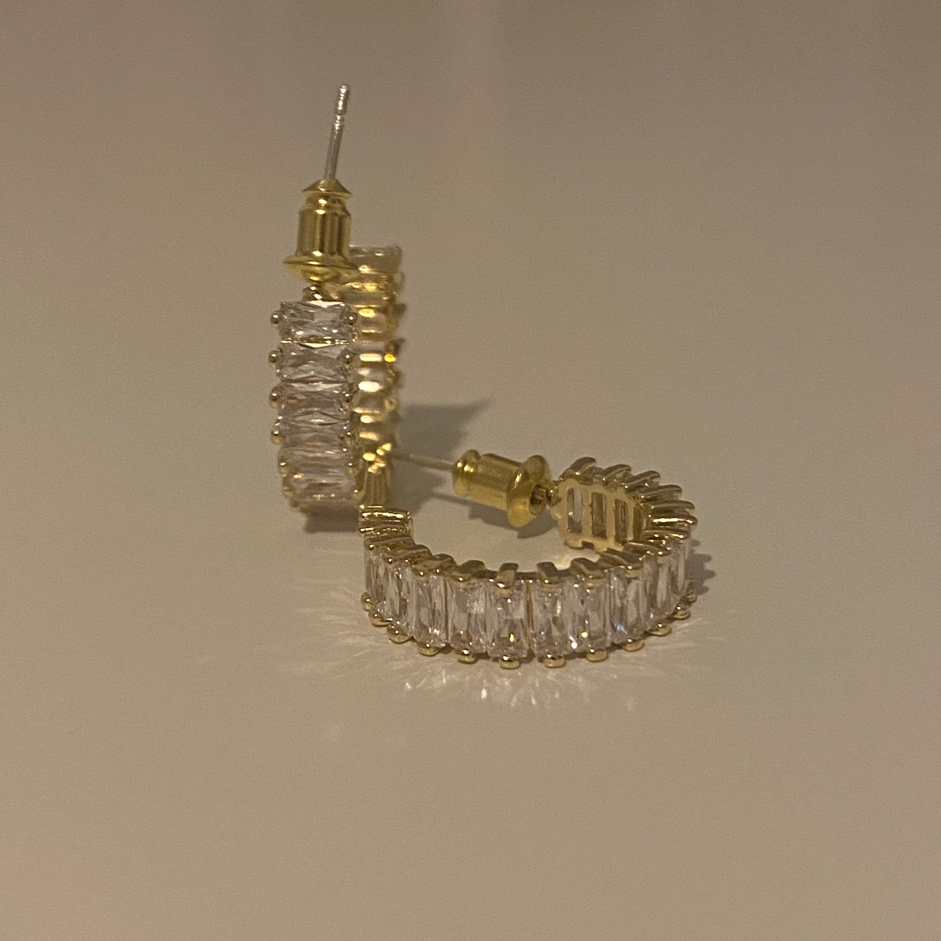 A pair of gold-plated hoop earrings with gold accents and bullet-clutch back, displayed against a white background.